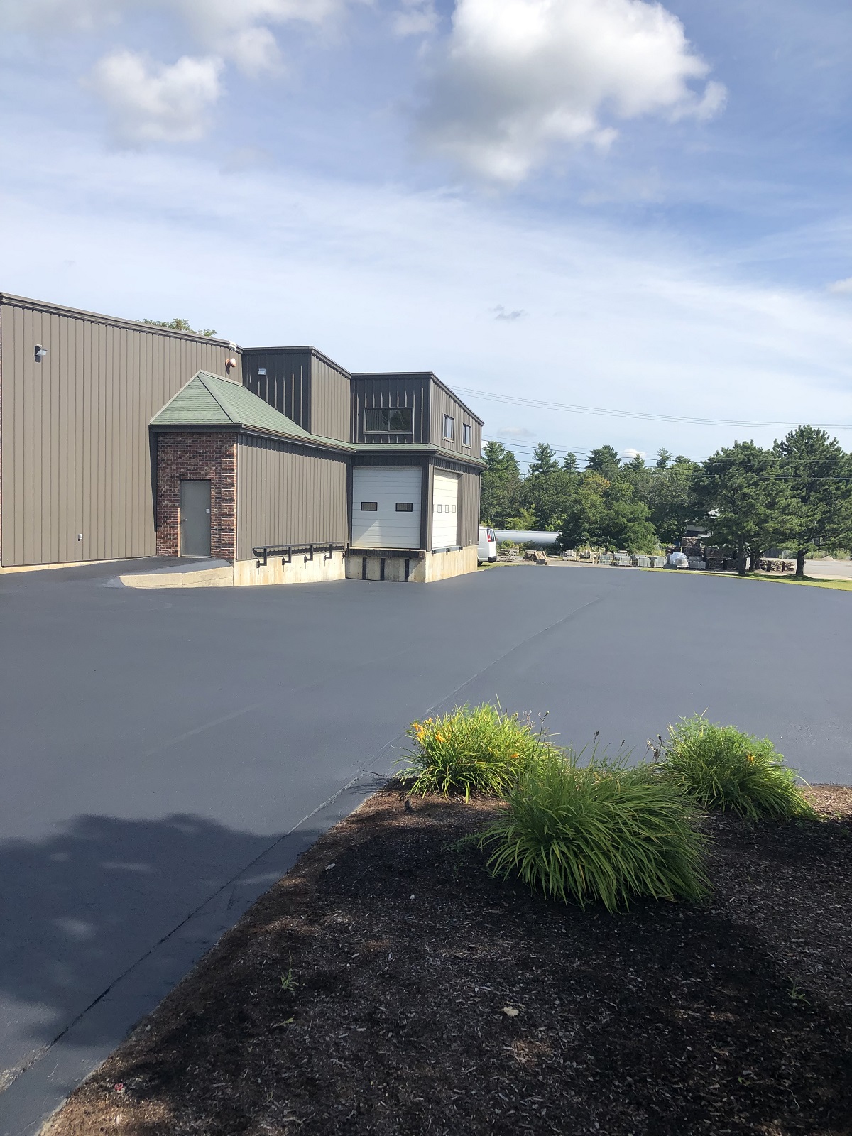 Freshly sealed industrial building parking area